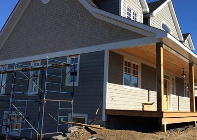 exterior cape code wood siding being installed on the exterior of a new home build