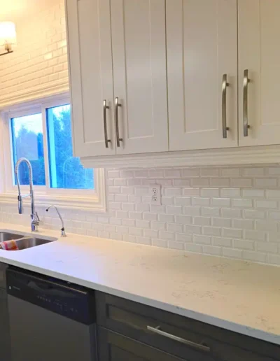 kitchen renovation with beautiful white subway tile and new cabinetry
