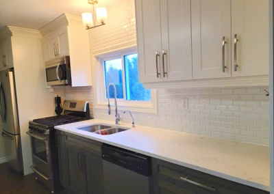kitchen renovation with new white subway tile being installed