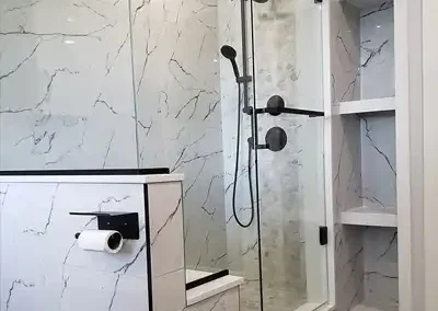 luxury marble walk-in shower with black faucet hardware