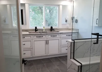 stunning bathroom renovation with gorgeous cabinetry and walk-in marble shower